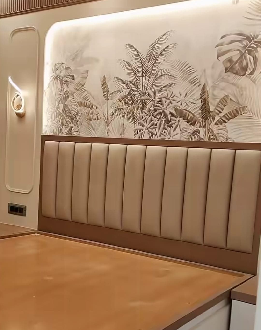 Bed with cushioned headboard and wallpaper