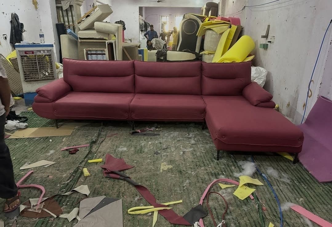 Maroon L-shape sofa being finished in the workshop